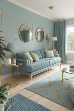 a living room with blue couches and mirrors on the wall above them, along with a rug