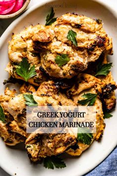 greek yogurt chicken marinade is served on a white plate with fresh herbs