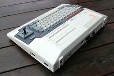 an old computer sitting on top of a wooden table