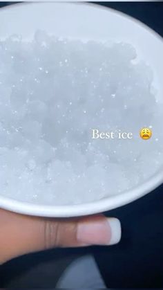 a person holding a white bowl filled with ice