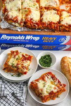 easy spinach lasagna recipe on a plate with bread and parmesan cheese