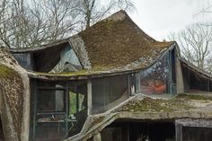 an old house with moss growing on the roof