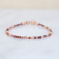 A beautiful natural faceted red Spinel bracelet with little Karen Hill Tribe rose gold vermeil nugget beads and a 14 carat rose gold filled clasp. The stones have each been hand selected for their natural colours, clarity and sparkle and the bracelet has an extender chain for perfect fit. Matching necklace and earrings available for the perfect gift set! This bracelet is customisable so if you would prefer rose gold or sterling silver, or if you would like a specific gemstone or colour, please d Dainty Rose Gold Beaded Bracelets For Jewelry Making, Rose Gold Beaded Bracelet With Gemstones, Rose Gold Beaded Bracelets With Faceted Round Beads, Rose Gold Gemstone Beaded Bracelet For Gift, Dainty Rose Gold Beaded Bracelet, Dainty Rose Gold Gemstone Bracelet, Rose Gold Faceted Bead Bracelet, Rose Gold Seed Bead Bracelet, Stone Bracelet Ideas