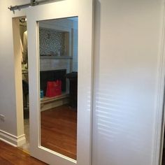 an empty room with sliding glass doors and hardwood floors