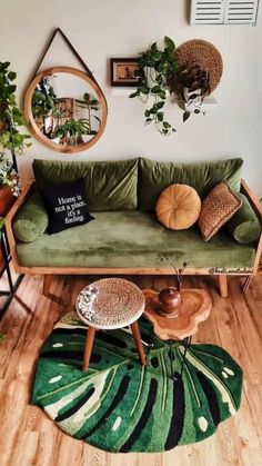 a green couch sitting on top of a hard wood floor next to a wooden table