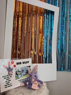 a stuffed animal next to a photo frame with an image of a bunny on it