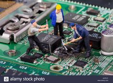 figurines are working on a computer motherboard - stock image