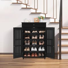 an open shoe cabinet with many pairs of shoes on it and stairs in the background