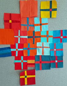 several pieces of art made out of different colored squares and rectangles on a gray surface