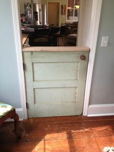 an open door leading to a kitchen and living room