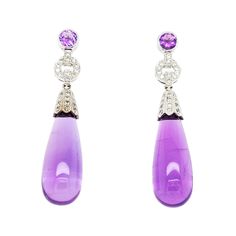 These amethyst drop earrings are crafted in 18 Karat white gold. Featuring 48 round brilliant cut diamonds of VS Clarity and G/H Color totaling 0.48 Carats. These earrings measure 1.75 inches long and have pierced posts with supportive, large friction backs. Amethyst Briolette Earrings For Formal Occasions, Formal Amethyst Briolette Earrings, Formal Purple Diamond Earrings, Diamond Drop Earrings, G H, Round Brilliant Cut Diamond, Gemstone Earrings, Round Brilliant, Amethyst