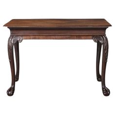 an antique wooden table with carved legs