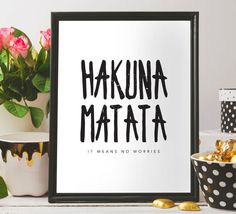 a black and white sign that says hakuna matata