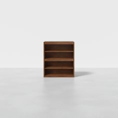 an empty bookcase on a white surface with no one in it or someone else