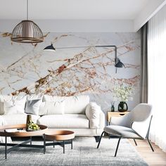 a living room filled with furniture and a marble wall behind the white couch, coffee table