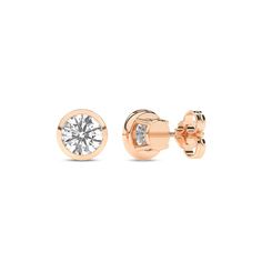 Immerse yourself in the understated beauty of our Round Solitaire Bezel Diamond Studs. Crafted with precision, each earring features a mesmerizing round diamond cradled in a sleek bezel setting. The minimalist design accentuates the lab-grown diamond's brilliance, making these diamond stud earrings a timeless addition to any jewelry collection. Rose Gold Diamond Earrings With Single Diamond, Diamond White Earrings With Tension Setting For Formal Events, Formal Earrings With Tension Setting, Rose Gold Round Cut Earrings With Single Diamond, Rose Gold Round Cut Single Diamond Earrings, Timeless Round Brilliant Cut Earrings, Moissanite Yellow Gold Round Diamond Earrings, Yellow Gold Moissanite Diamond Earrings, Anniversary Diamond Earrings With Tension Setting