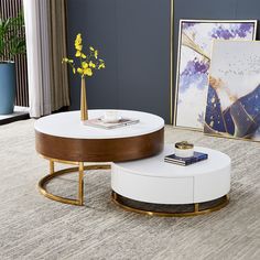 a white coffee table sitting on top of a rug next to a vase with yellow flowers