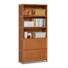 a wooden bookcase with three drawers and two baskets on the bottom shelf, against a white background