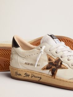 Dreaming of the Eighties. Our Ball Star sneakers have an American college vibe caught between a hoop shot and a skateboard ride. This version with a white nappa leather upper features a leopard-print pony skin star in shades of beige and brown, a black leather heel tab and a toe cap in ice-gray suede. The contrasting black Never Stop Dreaming lettering on the sole and the white laces add the finishing touch: beautiful things that never go out of fashion. Stop Dreaming, Never Stop Dreaming, Exclusive Sneakers, Shoe Inspo, Shades Of Beige, Black Heel, Star Sneakers, Black Leather Heels, Gray Suede