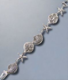 This Seashell Charm Bracelet is made of silver and features a magnetic closure, measuring 7 inches in length. It's lead and nickel free and consists of 7 pretty silver seashells. A must-have for any beach enthusiast. Beachy Anklets, Celebrity Style Jewelry, Flamingo Earrings, Cartilage Jewelry, Nose Hoop, Navel Rings, Magnetic Bracelet, Body Piercing Jewelry, Anklet Jewelry