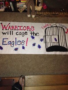 a sign that says, warriors will cage the eagles on it's back wall