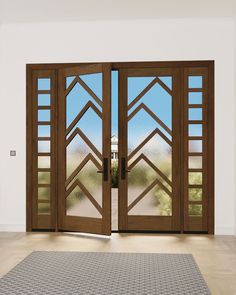 an open wooden door with glass panels on the inside and outside doors, in front of a white wall