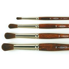 four wooden brushes are lined up in a row