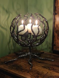 a candle holder with four candles in it