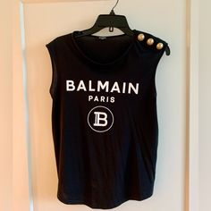 Authentic Balmain Black Logo Button Shoulder Muscle T-Shirt. Worn Two Times In Excellent Condition Such A Wonderful Addition To Any Wardrobe Can Wear With Anything To Spice. An Outfit Up. I Have Two And Have This Extra One. Runs Slightly Big. Black Buttoned T-shirt For Summer, Black Crew Neck T-shirt With Buttons, Black Crew Neck T-shirt With Button Closure, Chic Crew Neck Tops With Button Closure, Black Tops With Snap Buttons, Black Top With Snap Buttons For Summer, Black Tops With Snap Buttons For Summer, Black Summer Top With Snap Buttons, Summer Black Top With Snap Buttons