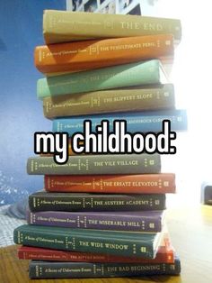 a stack of books sitting on top of a wooden table