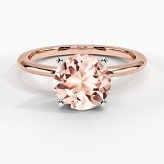 a rose gold engagement ring with an oval cut peach morganite stone in the center