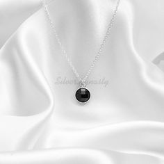 Stone : Black Onyx Metal : 925 Sterling Silver Stone : 10mm Shape :Round Comes with a Sterling Silver Chain Ships Worldwide from India 925 stamped Handmade Item OUR QUALITY * All our products are handcrafted to perfection with top quality 925 Sterling Silver and brilliant gem stones set in modern and traditional designs. * Each jewelry piece has an anti-tarnish coat to keep them vibrant and from tarnishing * Each gemstone is one of a kind and will display it's own unique personality ☆ * SilverDy Black Sterling Silver Birthstone Jewelry, Black Sterling Silver Jewelry With Birthstone, Black Faceted Round Necklace, Elegant Onyx Crystal Necklace For Gift, Faceted Round Onyx Jewelry, Elegant Round Black Crystal Necklace, Elegant Black Round Crystal Necklace, Minimalist Silver Onyx Necklace, Elegant Black Sterling Silver Crystal Necklace