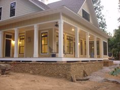 a house that is being built in the middle of the day with some lights on