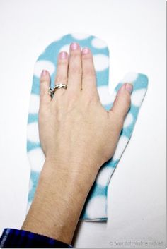 a person's hand on top of a blue and white towel