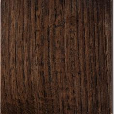 a wooden surface with dark brown stain on it