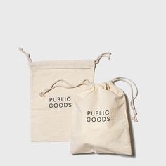 two bags with the words public goods printed on them, one in white and one in black