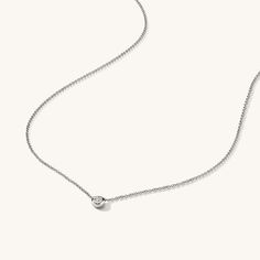 Elegant and timeless, the Solo Diamond Necklace showcases a single, brilliant diamond that sparkles with understated grace. Perfect for adding a hint of luxury to any look. 14k Gold Plating AAAAA Zircon Length 16" - 18" | 404mm - 457mm Diameter 0.16" | 4.1mm Thickness 0.04" | 1.06mm Adjustable Length Brilliant Diamond, Gold Plating, Silver Necklaces, Diamond Necklace, Gold Plate, Plating, Sparkle, Silver, Gold