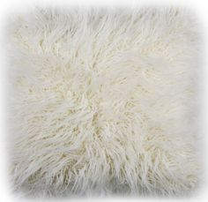 a white furry pillow on a white background