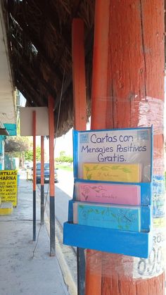 several books are stacked on top of each other in front of a sign that reads carras con menages business gritis