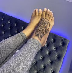 a woman's feet with a rose tattoo on her left leg and right foot