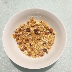 a white bowl filled with granola and nuts