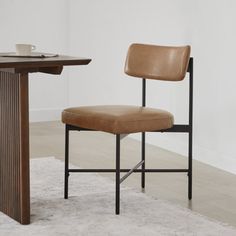 a brown chair sitting next to a wooden table on top of a white carpeted floor