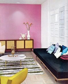 a living room filled with furniture and pink walls