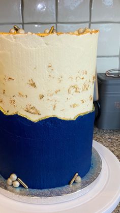 a blue and white cake sitting on top of a counter