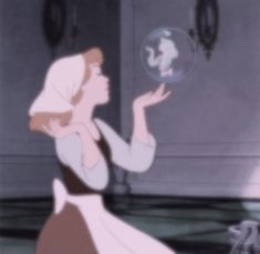 a woman in a white dress blowing bubbles