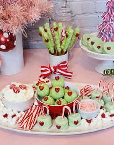 a table topped with lots of desserts and candy canes on top of plates