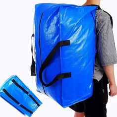 a man carrying a large blue bag on his back