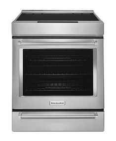 a stainless steel oven with the door open and its light on, in front of a white background