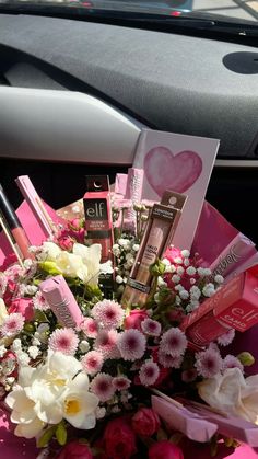 a bouquet of flowers sitting in the back seat of a car with lipstick on it