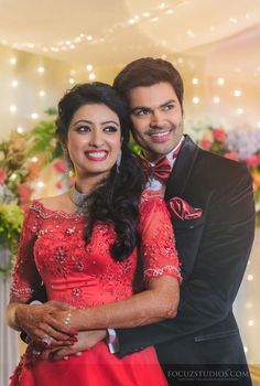 a man and woman dressed in red posing for a photo